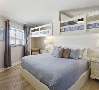 Guest bedroom with king bed and two bunk beds