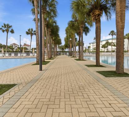 Two community pools lined with palm trees