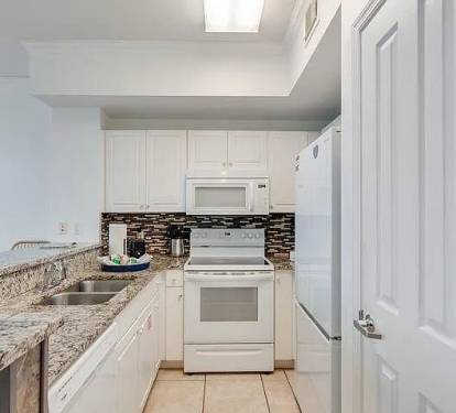 Fully equipped kitchen with granite counters&mdash;bright, modern, and ready to enjoy