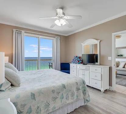 Relaxing bedroom with balcony access&mdash;wake to serene Gulf views and coastal charm