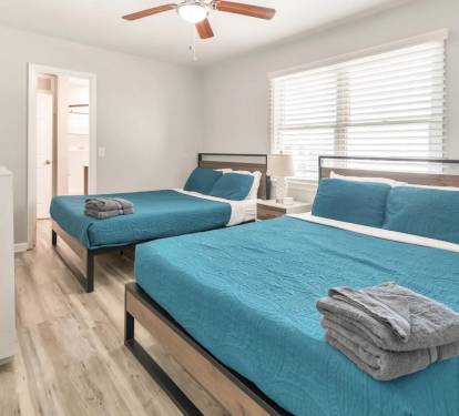 Relaxing bedroom with two beds and entertainment setup