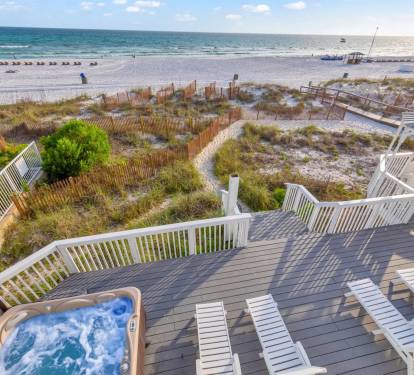 Step straight onto the sand from this beautiful beachfront home with large outdoor living areas.