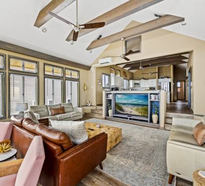 Unwind in style with this spacious living room featuring breath-taking ocean views.