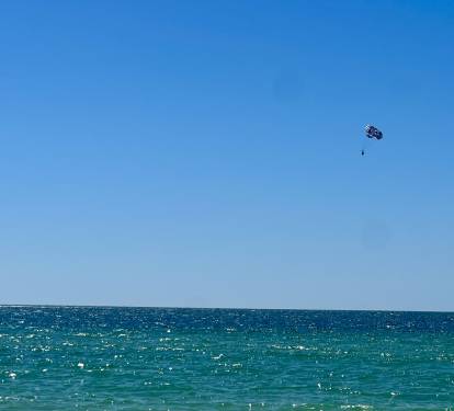 White sand and Turquoise Water and parasailing close by