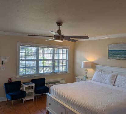 king bed with storage and two chairs and a side table