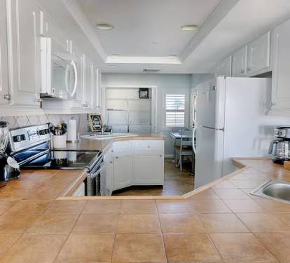 Large modern kitchen with washer and dryer.