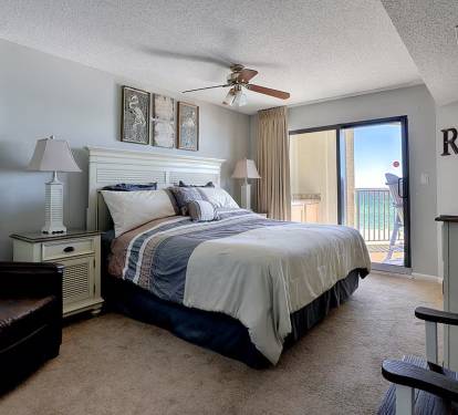 Master bedroom with sliding glass door walking onto the balcony.