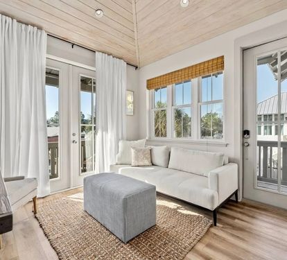 Kick back on the sofa as light pours through the French doors.
