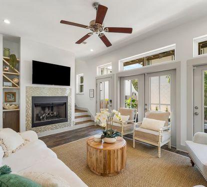 Open living with a fireplace, smart TV, and vaulted ceilings