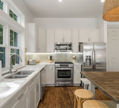 A real chef's kitchen&mdash;stainless steel appliances, white cabinets, room to cook