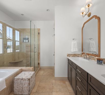 A spa-worthy primary bath with a soaking tub, glass walk-in shower, and double vanity &mdash; bathed in natural light