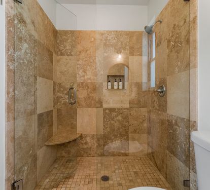 Second-floor King Suite 3- ensuite bath features a spacious walk-in shower with built-in bench