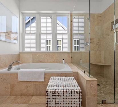Soak away the day in a deep tub beneath sunlit windows in the top-floor Primary King Suite private bath
