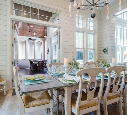 Dining table seats 10 beneath oysters shell chandelier