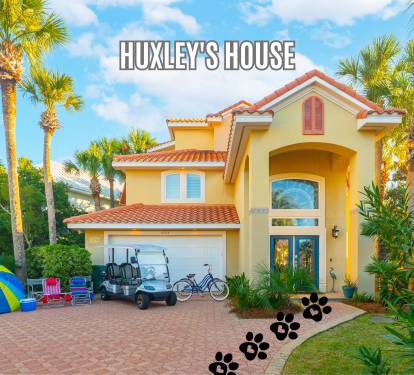 Welcoming front exterior surrounded by palms and vibrant landscaping
