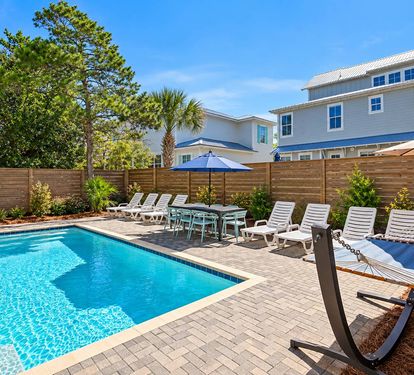 The private pool area features lounges, poolside tables and chairs, a hammock, and a grill.