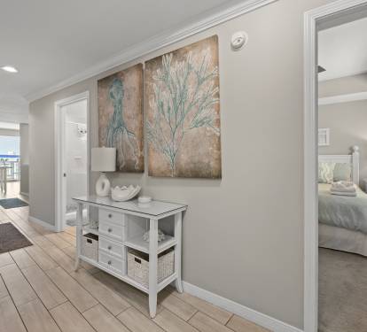 Cozy bedroom corner w/ artwork and soft lighting for restful nights.
