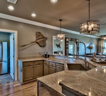 Kitchen with NOLA faucet, zero radius sink and stainless appliances.
