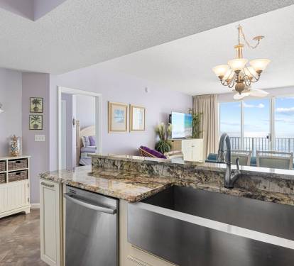 Wide-angle look at the main living space connecting kitchen & seating areas.