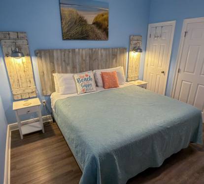 This inviting bedroom pairs calming blue hues with weathered wood accents for a serene, seaside-inspired escape.