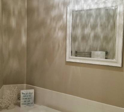 Decorative pendant light casts soft patterns across the ceiling, adding a warm, elegant glow to the space.