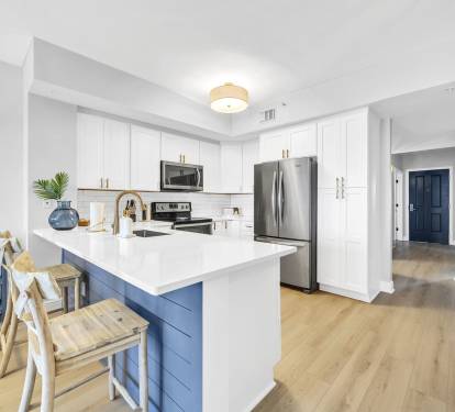 Cook, gather, and connect in this bright, fully equipped kitchen featuring modern appliances, spacious countertops, and bar seating—perfect for everything from quick breakfasts to family meals.