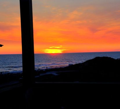Sunset from upper deck. A twin size bed swing was recently added to relax and take in the gulf views from the top deck.