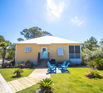 Front of Cottage, parking to the Left of wood sidewalk