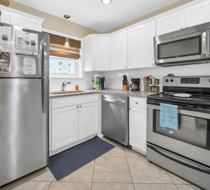 Open, well stocked kitchen with granite countertops, dishwashwer