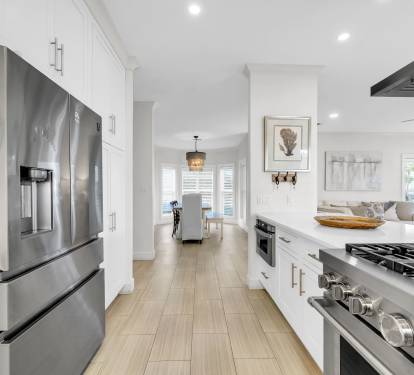 Stainless steel appliances, including dishwasher and fridge with icemaker.