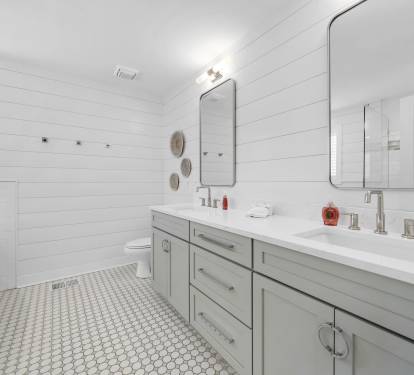 Spacious master bath with dual vanity sinks and large mirror.