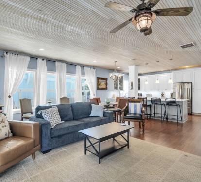Family room with large tv and plenty of seating.