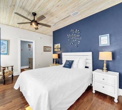 1st floor BR with queen bed, large screen tv, doors to pool area, ensuite bath.