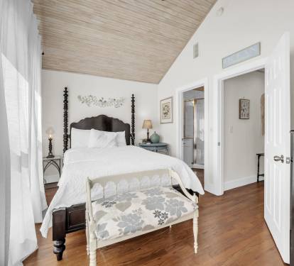 Upstairs BR with queen bed, tv, balcony and ensuite bath.