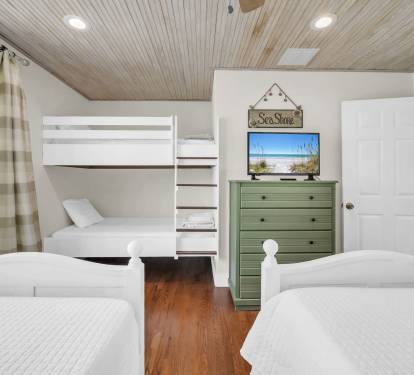 Upstairs BR with two twin beds and two twin bunk beds - room sleeps 4 total.