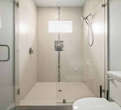 Grand Master ensuite bath featuring a modern walk-in shower with glass enclosure.