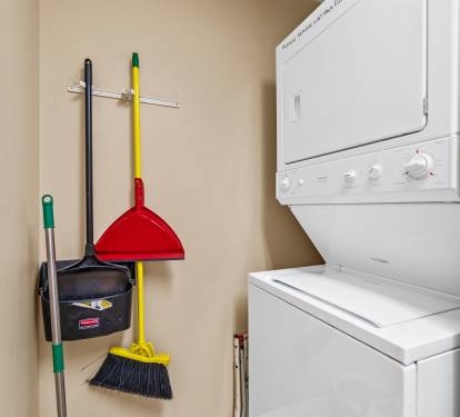 Laundry room with double stacked  washer and dryer