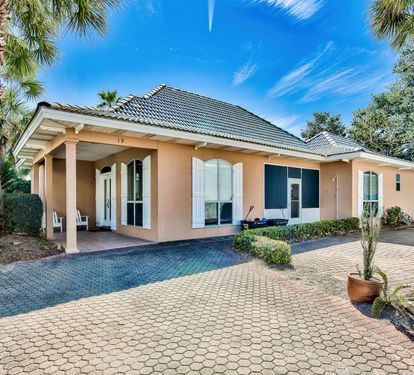 Real Sandy exterior with private driveway and beautifully maintained coastal landscaping