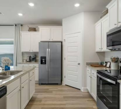Spacious kitchen featuring counter seating, a 2-door fridge, and full cooking essentials.