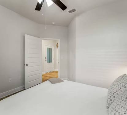 Bedroom 1: Modern bedroom with ceiling fan, and elegant bedside table lamps