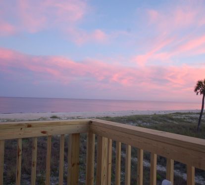 Pink sky from the deck overlooking the ocean 