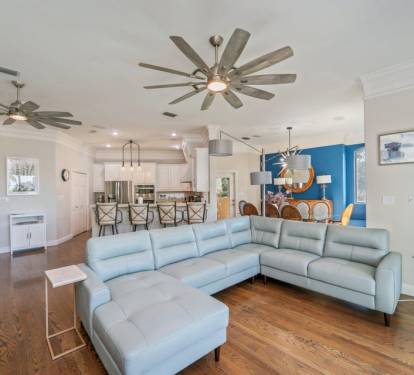 Spacious open-concept living area w/ plush seating that flows easily into the kitchen & dining space