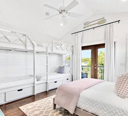 The 3rd floor bunk room: four twin XL bunks, a queen bed, and a dedicated wet bar with mini fridge. Comfortable for adults...or the kids get their own floor — everyone wins!