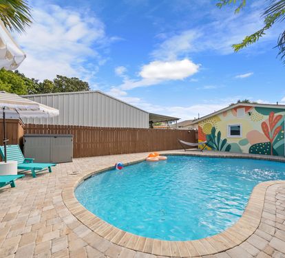 Lounge poolside with a colorful mural as your backdrop and
a pool toy at arm's reach. This is the backyard view that greets you every morning.