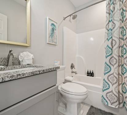 King Suite ensuite bathroom featuring granite vanity and modern fixtures.