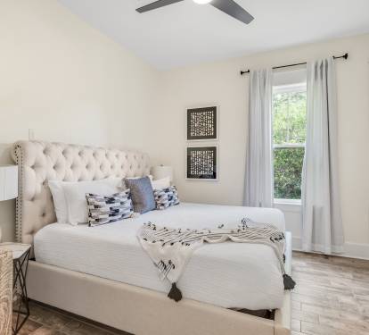 King bedroom w/ fan, 55" TV, closet & dresser.