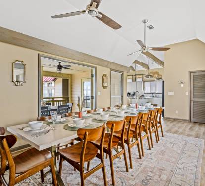 Create new memories with friends and loved ones in this bright dining area that can comfortably seat 14 people. There are 10 additional dining places in the kitchen and 6 in the screened-in po