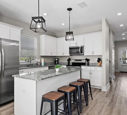 The kitchen is equipped with a large two-door refrigerator with ice maker, stove, oven, coffeemaker and dishwasher.