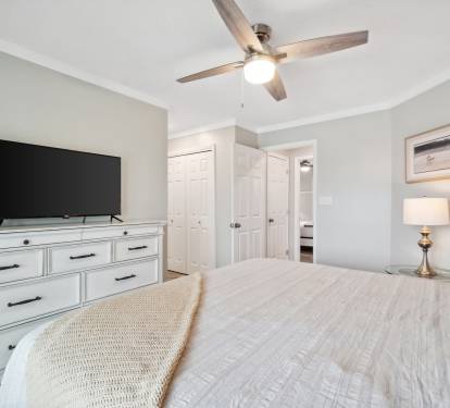 Master bedroom with large smart TV