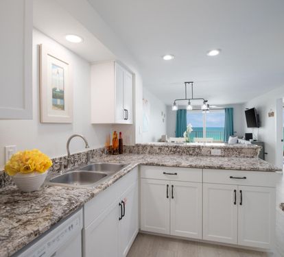 "Whip up your favorite meals in this bright and fully-equipped kitchen, featuring granite countertops and modern appliances. ??? #BeachsideCooking #VacationEats"